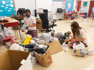 Fifth graders’ Socktober drive warms the hearts and feet of area homeless
