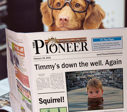 Dog reading Pioneer newspaper